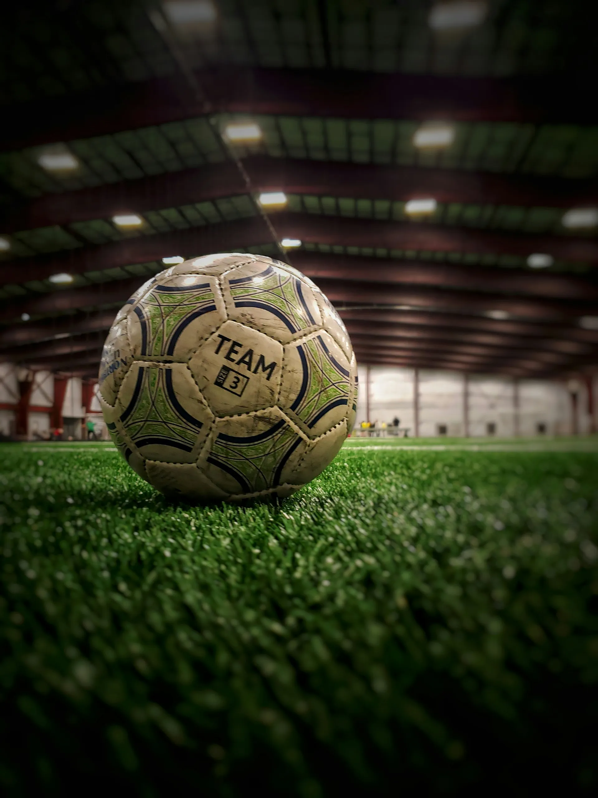 A match ball on the turf of an indoor soccer arena